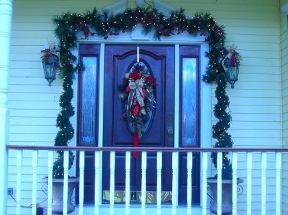We like to offer a simple natural looking artificial decor to add charm to a front entrance.  This is easy to store and will last many years.  Using weather proof ribbon, and berries, makes this a long lasting investment, and a quick yearly joy to put in place.  You know it can be pretty cold when it is time to put these darn things up. The last thing you want to do is spend more time than you like out there doing it.  Mull the wine I'll be in one minute!